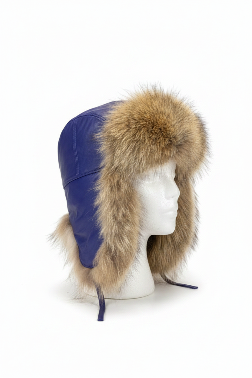 A blue leather aviator-style trapper hat with a large tan and brown fur trim, displayed on a white mannequin head against a white background.