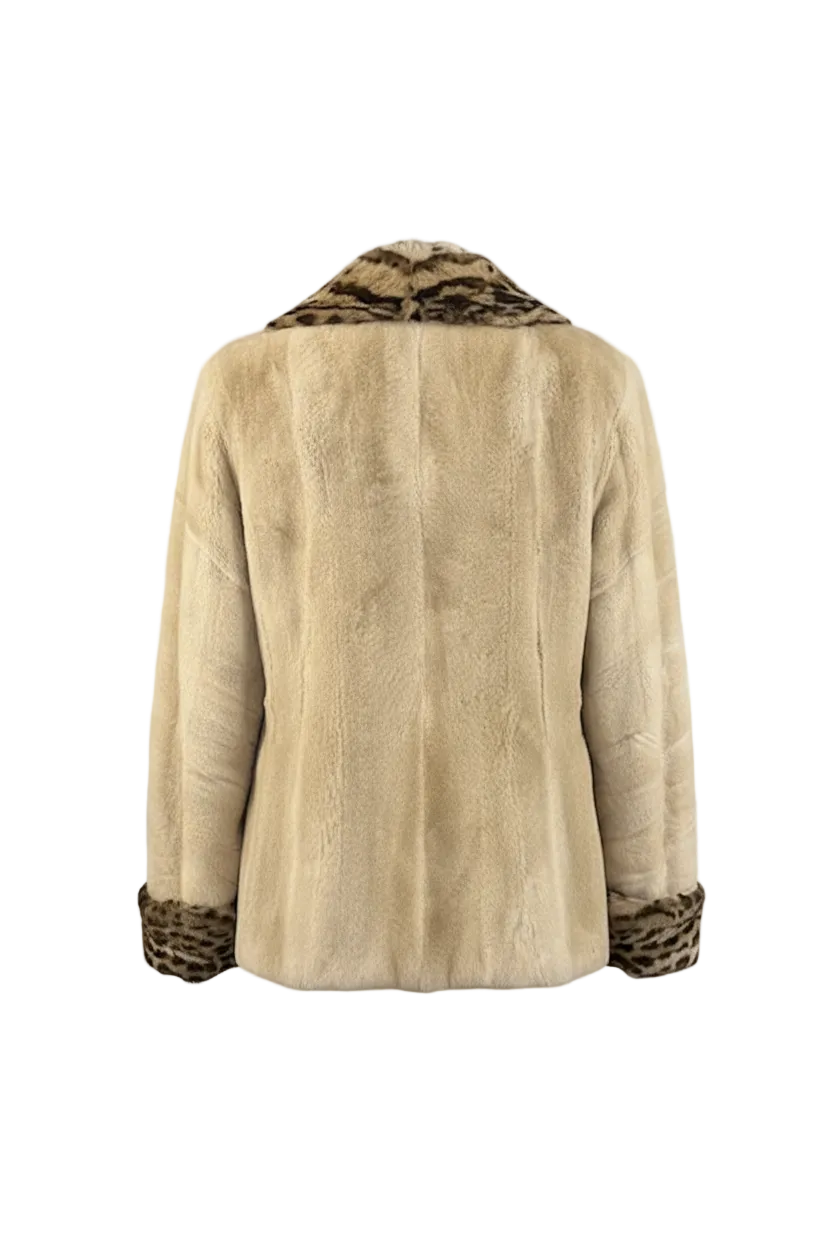 A beige fur jacket shown from the back, featuring a patterned brown and black leopard-print collar and cuffs, displayed on a checkered transparency background.